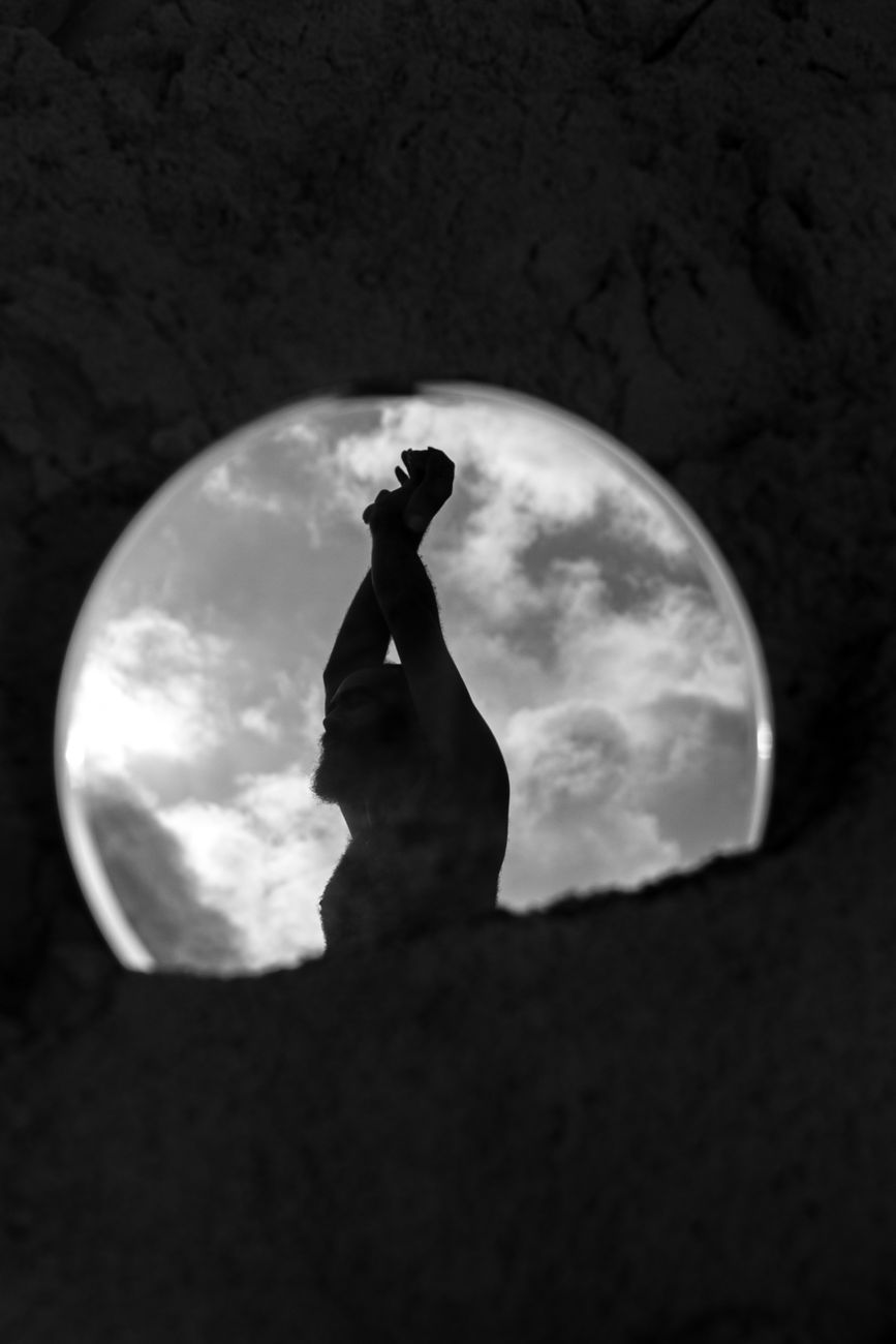 a person is standing in a round mirror